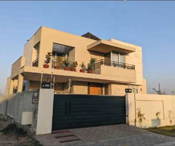 Finished house with a dark gate in M Block, DHA Phase 5, Lahore