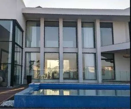Glass facade and pool of a modern villa in DHA Phase 5, Lahore