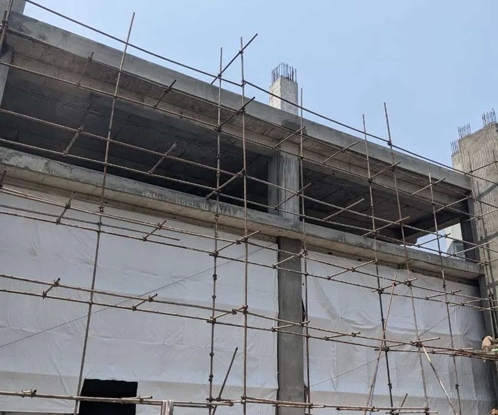 Building structure with scaffolding on MM Alam Road, Lahore