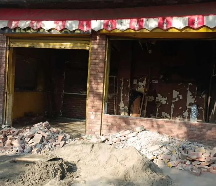 Shopfront before the interior works, with debris and bare walls, Lahore