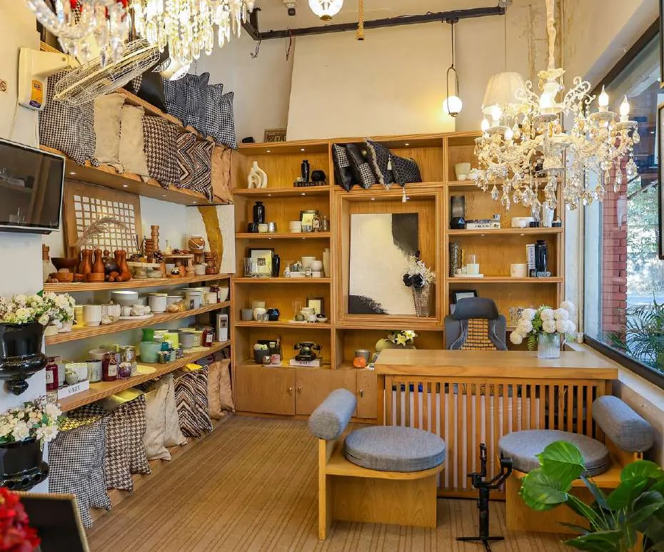 Finished studio interior with fitted wooden shelving and chandeliers, Lahore